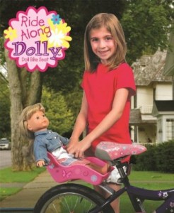 girl attaching a doll carrier to her bike